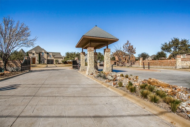 surrounding community with a gate and fence