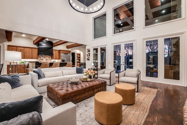 45 Dunrobin, Richardson, TX 75082 - living area with a high ceiling, arched walkways, wood finished floors, a chandelier, and beamed ceiling