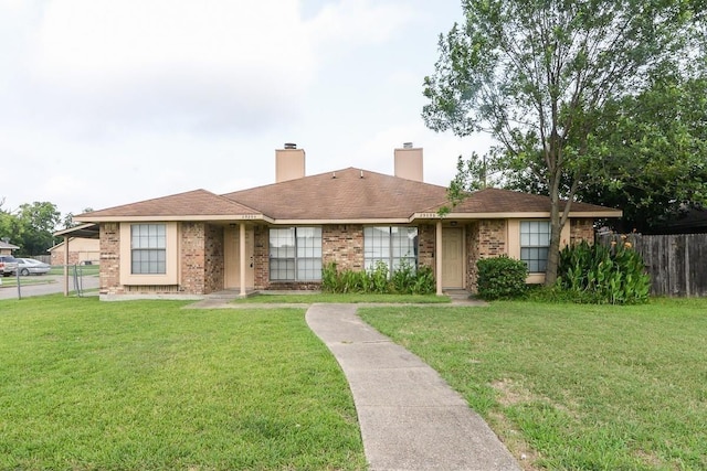 single story home featuring a front lawn