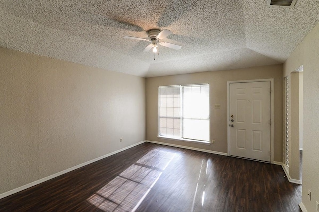 spare room with a textured ceiling, dark wood-type flooring, and ceiling fan