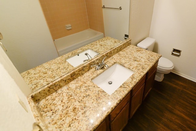 bathroom featuring vanity, toilet, and hardwood / wood-style floors