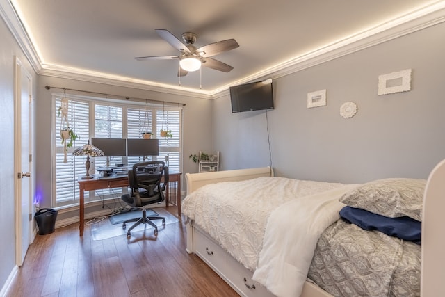 bedroom featuring crown molding, ceiling fan, and hardwood / wood-style floors