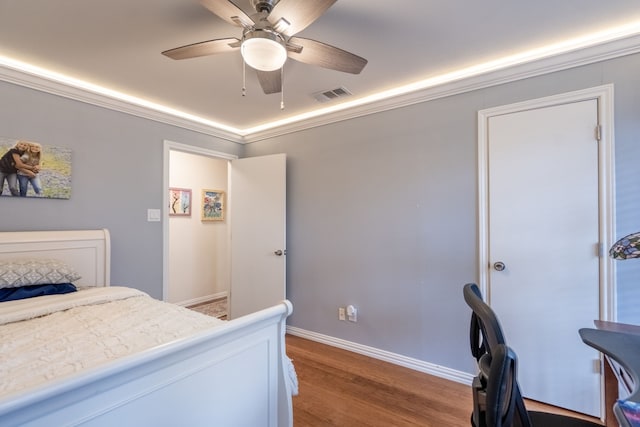 bedroom featuring wood-type flooring, ceiling fan, and crown molding