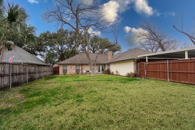 rear view of property with a lawn