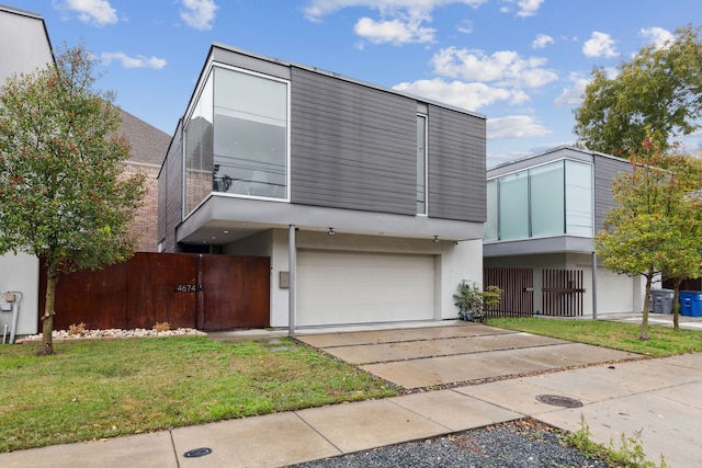 modern home with a garage and a front lawn