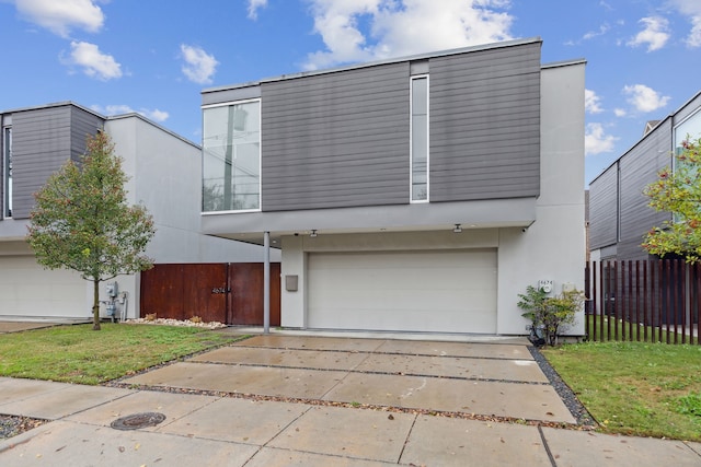 view of front of property featuring a garage and a front lawn