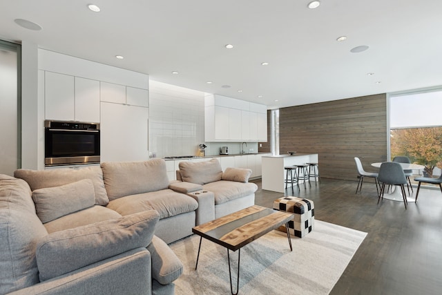 living room featuring hardwood / wood-style flooring and wood walls