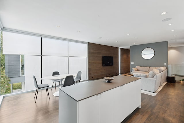 kitchen featuring white cabinetry, floor to ceiling windows, dark hardwood / wood-style floors, and a center island