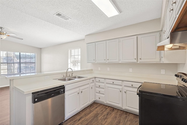 kitchen featuring dishwasher, sink, white cabinets, electric range, and kitchen peninsula