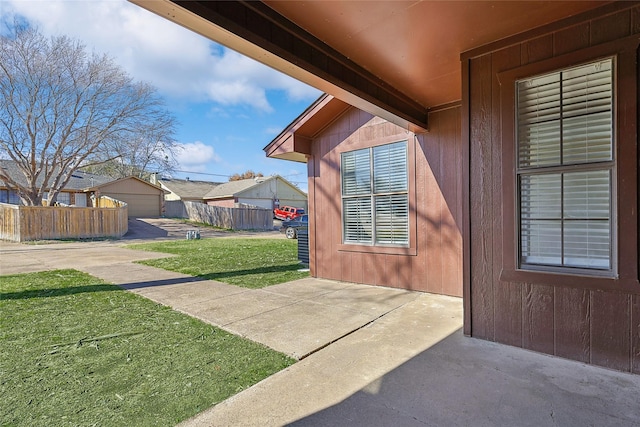 doorway to property with a yard and a patio area