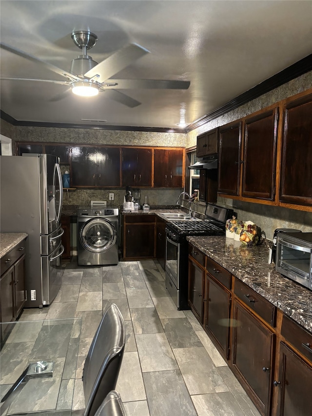 kitchen featuring range hood, washer / clothes dryer, sink, dark stone counters, and stainless steel appliances