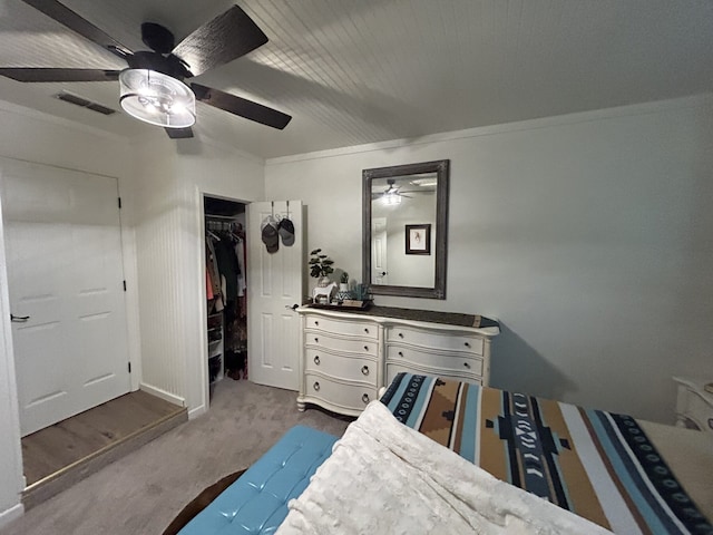 bedroom with ceiling fan, ornamental molding, and a closet