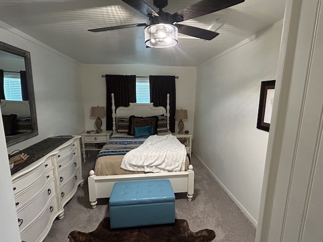 carpeted bedroom featuring crown molding and ceiling fan