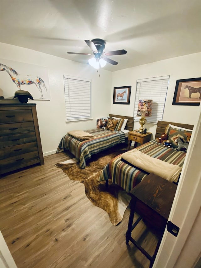 bedroom with hardwood / wood-style flooring and ceiling fan