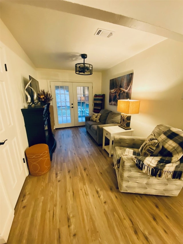 living room with hardwood / wood-style flooring and french doors