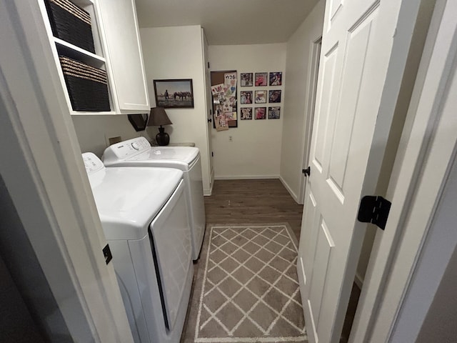 laundry room featuring cabinets, hardwood / wood-style flooring, and washer and dryer