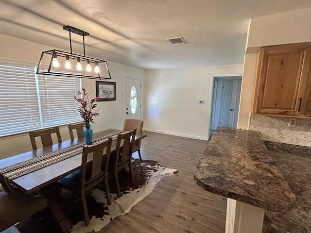 dining room with dark wood-type flooring