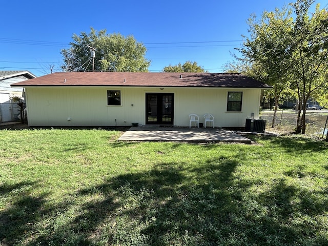 back of property with a yard, a patio area, and central air condition unit