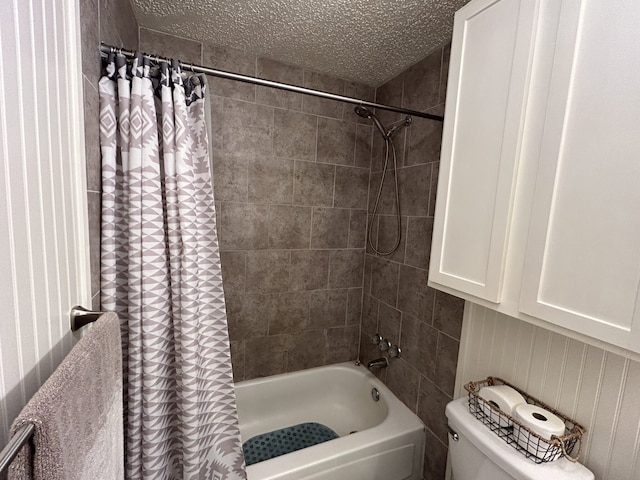 bathroom featuring shower / bath combo, a textured ceiling, and toilet