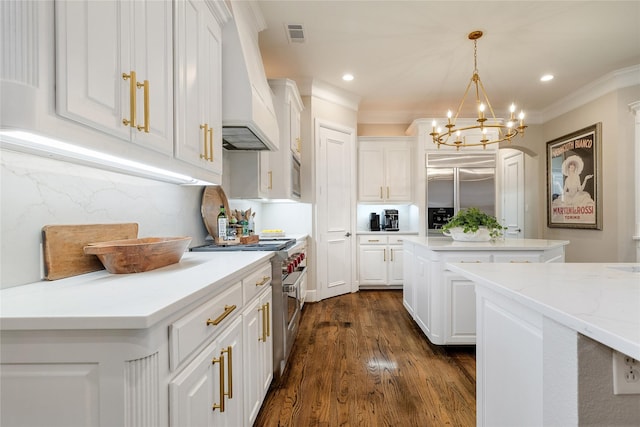 kitchen with a kitchen island, pendant lighting, white cabinets, premium appliances, and custom exhaust hood