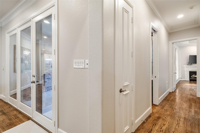 hall featuring wood-type flooring and ornamental molding