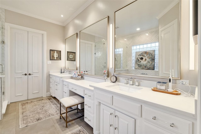 bathroom with a shower with door, ornamental molding, vanity, and tile patterned floors