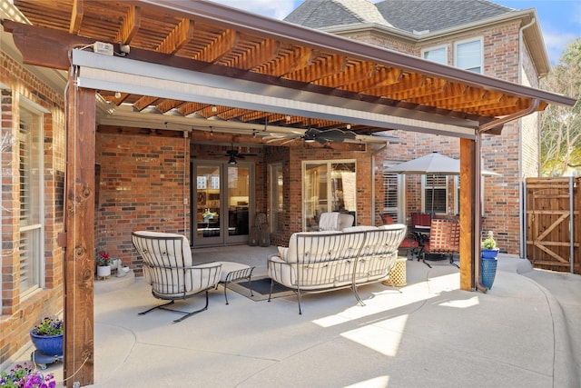 view of patio featuring an outdoor living space, ceiling fan, and a pergola