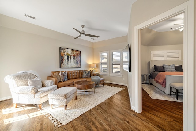 living room featuring dark hardwood / wood-style floors and ceiling fan