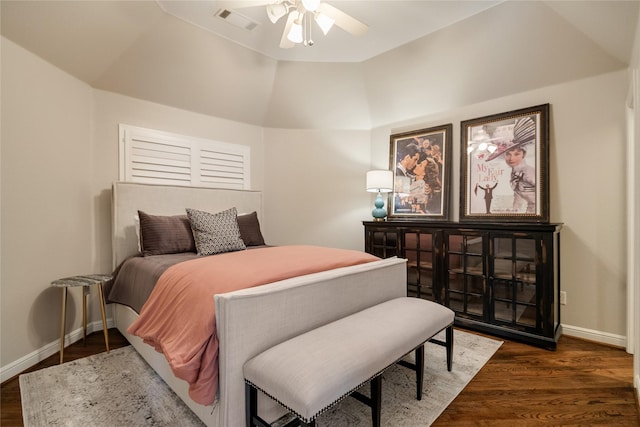 bedroom with dark hardwood / wood-style flooring, lofted ceiling, and ceiling fan