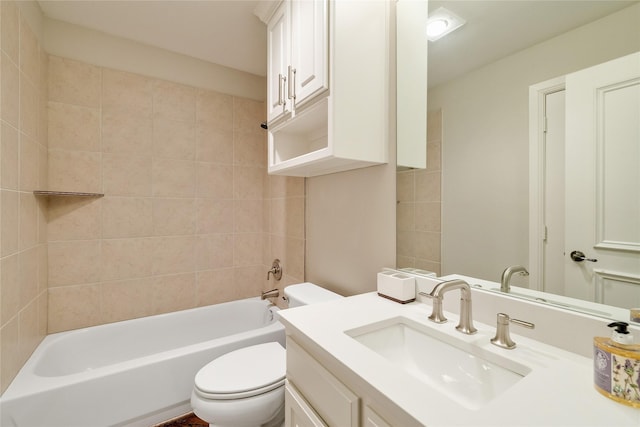 full bathroom featuring tiled shower / bath, vanity, and toilet