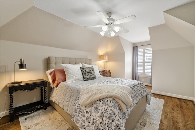 bedroom featuring wood-type flooring, lofted ceiling, and ceiling fan