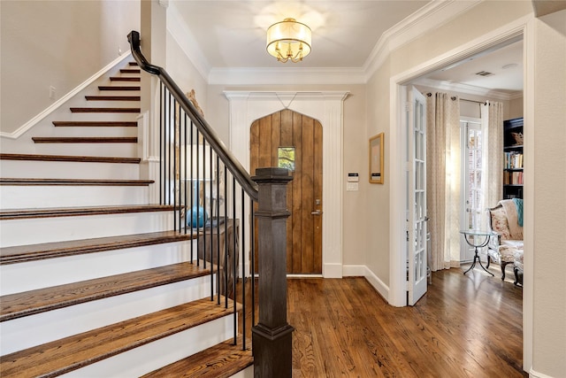 entrance foyer featuring crown molding and dark hardwood / wood-style flooring