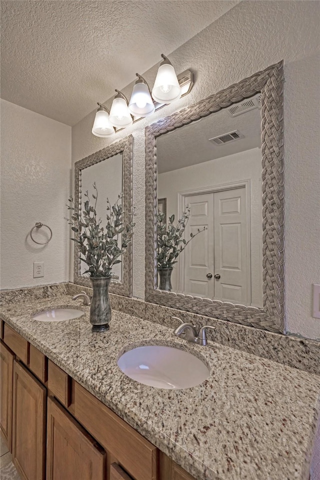 bathroom with vanity and a textured ceiling