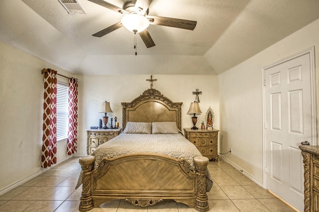 bedroom featuring ceiling fan, a textured ceiling, and light tile patterned flooring