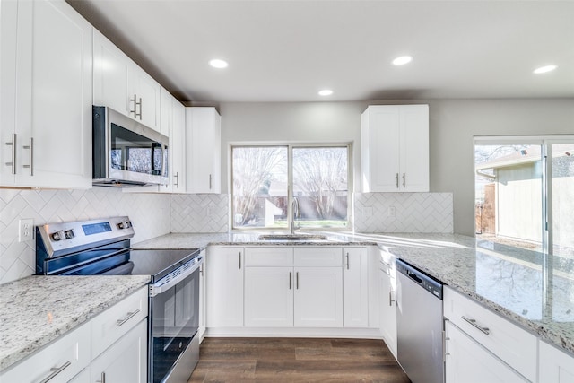 kitchen featuring stainless steel appliances, sink, and white cabinets