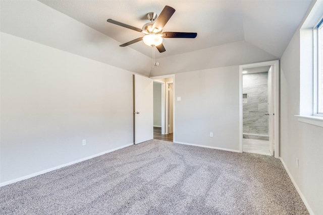 spare room with vaulted ceiling, carpet, and ceiling fan