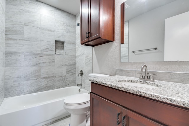 full bathroom with tiled shower / bath combo, vanity, and toilet