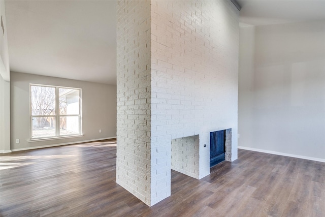 unfurnished living room featuring dark hardwood / wood-style flooring and a fireplace