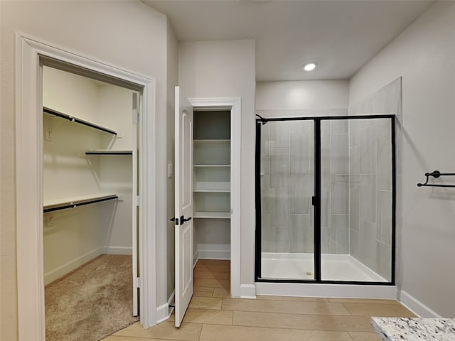 bathroom featuring wood-type flooring and walk in shower