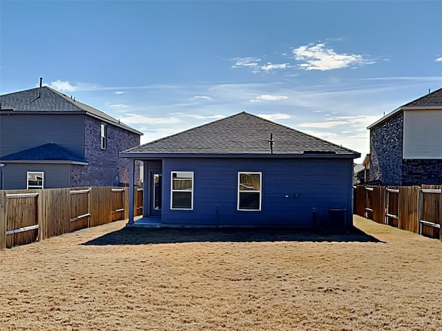 back of house with central AC