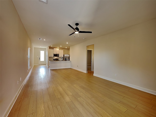 unfurnished living room featuring light hardwood / wood-style floors and ceiling fan