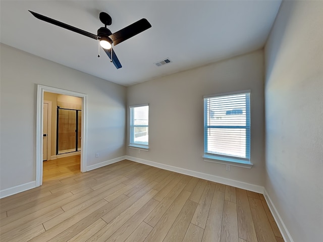 spare room with ceiling fan and light wood-type flooring