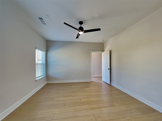 empty room with ceiling fan and light wood-type flooring