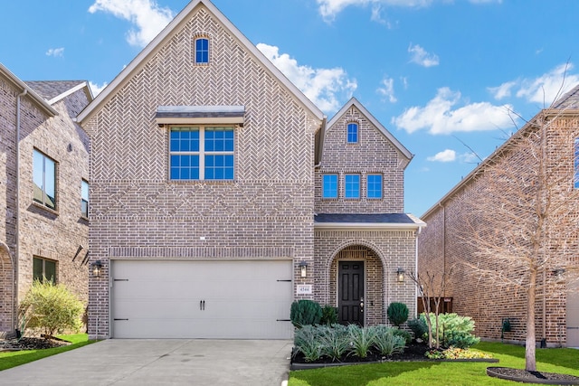 view of front of home with a garage and a front yard