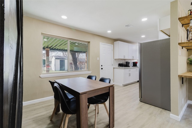 dining space with light hardwood / wood-style flooring