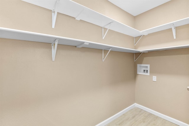 laundry area featuring hookup for a washing machine and hardwood / wood-style flooring