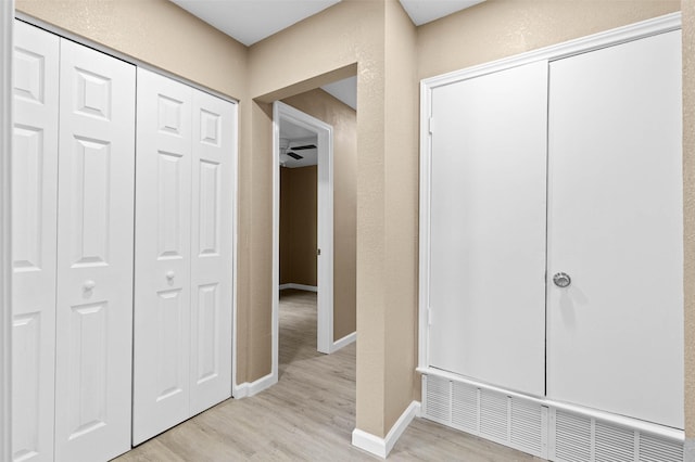 hallway with light wood-type flooring