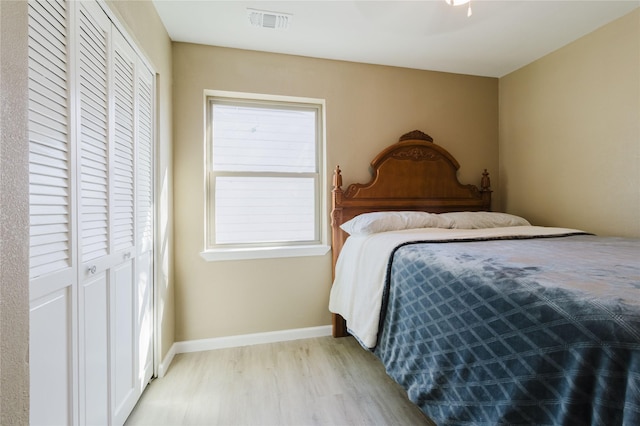 bedroom featuring light hardwood / wood-style floors and a closet