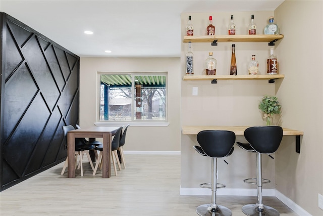 bar featuring light wood-type flooring