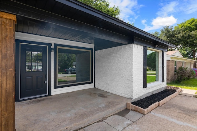 property entrance featuring a patio